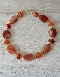 Orange Striped Agate Necklace featuring 35MM oval orange striped agate stones accented with carnelian nuggets and fire opal Swarovski crystals and gold plated spacers. Gold filled toggle clasp. GIFT BOXED Carnelian Bracelet Ideas, Orange Necklaces, Orange Choker, Fire Agate Jewelry, Orange Jewelry, Necklace Orange, Carnelian Bracelet, Carnelian Necklace, Bracelet Display