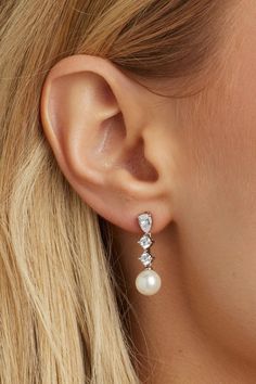 Indulge in timeless elegance with these crystal stud earrings with a delicate pearl drop on the end. Their subtle yet stunning design makes them a must-have accessory for any bride. Pear-shaped Pearl Drop Bridal Earrings In White Gold, Timeless Evening Bridal Earrings With Cubic Zirconia, White Gold Bridal Earrings Teardrop Elegant Design, Elegant White Gold Teardrop Bridal Earrings, Elegant Pearl White Pearl Drop Earrings, Elegant Teardrop White Gold Bridal Earrings, Elegant Pearl White Earrings With Pearl Drop, Exquisite Teardrop Bridal Earrings For Formal Occasions, Elegant Pearl Dangle Jewelry