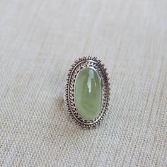 Gemstone - Natural Prehnite Metal - Sterling Silver Ring size - All sizes available Each Ring made with Precision and love, these rings are perfect for everyday use and a perfect accessory to wear at work. Rings can be customized on request and gemstone can be switched to any other as per requirement. kindly visit my store to view the complete collection. Feel free to contact me for any queries regarding jewelry or for bulk order. The ring will be gift wrapped in a premium handmade jewelry box Green Large Stone Ring Jewelry, Green Large Stone Ring, Spiritual Green Gemstones For Gifts, Green Spiritual Gemstones For Gifts, Spiritual Green Gemstones For Gifting, Oval Cabochon Emerald Ring Gift, Heirloom Jade Jewelry In Green, Heirloom Green Jade Jewelry, Peridot Gemstone Ring Gift