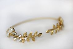 This stunning and unique bracelet is based on a strong and adjustable base that is decorated on each side with a beautiful long and detailed twig leaves, along with some pearls and crystals. This piece is so dainty and feminine. It will be a stunning edition to a special even just as much as a delicate piece to wear on an everyday basis. Circumference is around 15cm / 6inch. This size could be slightly adjusted to become bigger or smaller.* Comes wrapped in a pretty gift packaging* Comes in 14k Bohemian Wedding Bracelet With Adjustable Chain, Bohemian Wedding Bracelets With Adjustable Chain, Bohemian Wedding Bracelet With Jewels, Bohemian Wedding Bracelets With Jewels, Unique Adjustable Cuff Bracelet For Wedding, Unique Adjustable Bangle For Wedding, Gold Resizable Bracelets For Wedding, Leaves Bracelet, Delicate Gold Bracelet