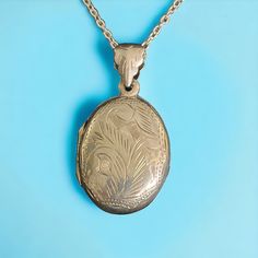 "Vintage sterling silver oval locket on chain. Space for two photos. The locket is 1.4 \" inches long including the bail, and 0.8\" inch wide. The more modern chain is 17\" inches long, and is only silver plated. Both are in very good condition. The locket is marked 925, for sterling silver. A lovely Valentine's Day, Anniversary, Birthday, Mother's Day gift for that special someone. Please contact me for combined shipping." Antique Silver Sterling Silver Oval Locket Necklace, Vintage Sterling Silver Engraved Locket Necklace, Vintage Silver Etched Locket Necklace, Antique Etched Sterling Silver Locket Necklace, Engraved Silver-colored Brass Locket Necklace, Locket Vintage, Engraved Locket, Sterling Silver Locket, Oval Locket