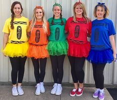 four girls in costumes standing next to each other