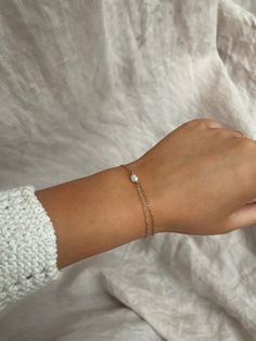 A one of kind, organic Pearl sits on a delicate gold filled chain, which wraps around the wrist twice, giving a stacking bracelet in one. Sizes are listed as the length of a normal, single bracelet, so if you select wrap bracelet it will be longer than the stated size but will fit the same sized wrist. Sterling silver option here: https://www.etsy.com/listing/1477959813/small-pearl-bracelet-sterling-silver Pearl is a June birthstone and a natural sign of strength, protection and most notably enduring love, making it a lovely gift for a bride, or your bridesmaids, especially.  The Pearl measures approximately 4mm and is a genuine freshwater Pearl in its natural shape. Each bracelet has a 1/2 inch extension chain with another irregular Pearl attached. If you would like a shorter or longer ex Delicate Chain Bracelet With Jubilee Details As Gift, Delicate Chain Link Bracelet For Gift, Delicate Gold Bracelet With Chain As Gift, Dainty Chain Bracelet As Gift, Delicate Gold Jubilee Bracelet As Gift, Simple 14k Gold Bracelets As Gift, Dainty Gold Chain Bracelet With Birthstone, Delicate Jubilee Chain Bracelet As Gift, Delicate Jubilee Chain Bracelet For Gifts