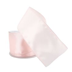 a roll of pink satin ribbon on a white background