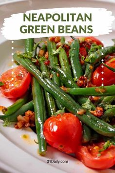 a white plate topped with green beans and tomatoes