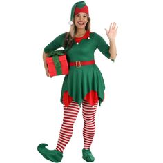 a woman dressed in christmas attire and holding a present box while standing on one leg