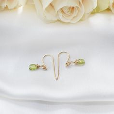 Feel the fresh touch of elegance with these peridot drop earrings! The gold peridot earrings add class and sophistication to all your outfits. Each faceted peridot shines and shimmer reflecting light when you turn your head. Peridot’s heart-centered energy empowers you to live your life with an openness to change and new experiences. The stone is genuine peridot in 14k gold-filled metal setting Teardrop peridots measure 0.28 inches tall by 0.20 inches wide (7mm tall by 5mm wide) You easily put e Elegant Lime Green Faceted Jewelry, Gold Peridot Earrings Fine Jewelry, Elegant Lime Green Earrings For Gift, Peridot Drop Earrings For May Birthstone, Yellow Gold Peridot Teardrop Jewelry, Peridot Teardrop Earrings For May Birthstone, Teardrop Peridot Earrings For May Birthstone, Elegant Peridot Birthstone Earrings, Elegant Peridot Dangle Earrings