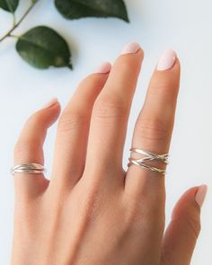 This beautiful wrapped ring will become a staple in your wardrobe! This ring is handcrafted out of a D-shaped (half round) wire, and is a thicker take on our classic wrap-style ring. This listing is for ONE single ring in STERLING SILVER. SIZING NOTE: Because this style is wider than a classic Stacking Ring, we recommend sizing up* by a QUARTER to a HALF size from your US Fashion Ring Size (Bridal size is different than US Fashion Ring Sizing!). Sizing up when purchasing a larger ring style will Adjustable Bypass Ring With Modern Twist, Modern Twist Adjustable Bypass Ring, Adjustable Twisted Modern Jewelry, Modern Adjustable Twisted Jewelry, Elegant Spiral Stackable Rings, Modern Twist Midi Rings With Open Band, Midi Rings With Open Band And Modern Twist, Modern Twist Infinity Stackable Rings, Adjustable Infinity Stackable Rings With A Modern Twist