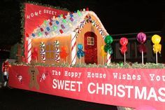 a house with candy canes on the roof is decorated in red, white and green