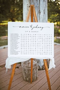 a wooden easel with a sign on it that says, wedding seating list and location