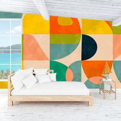 a bed sitting in front of a colorful wall