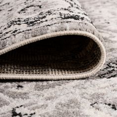 a close up view of a rug on the floor with an area rug underneath it