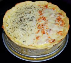 two pizzas sitting on top of metal pans covered in cheese and toppings