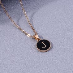 This elegant 26-letter pendant necklace is crafted with A-Z letters for a personalized look. The gold color and black enamel background make it a perfect addition to any ensemble. An ideal gift for any special occasion, this necklace lets you customize it with the initial of your choice. Luxury Personalized Pendant Initial Necklace, Enamel Initial Pendant Necklace As Gift, Black Personalized Initial Pendant Jewelry, 14k Gold Filled Jewelry, Initial Pendant For Personalized Gift, Personalized Gold-tone Initial Pendant Necklace, Jewelry Name, Alphabet Necklace, Letter Pendant Necklace, Name Initials