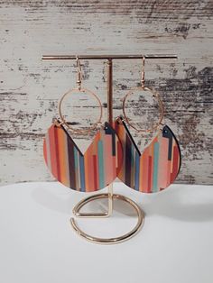 Add a touch of contemporary sophistication to your jewelry collection with these stunning geometric earrings. Expertly handcrafted with attention to detail, these earrings are designed to elevate your style and make a bold statement.  Materials:  - Zinc alloy  - Wood  Dimensions: - 8CM x 4.7CM  Why Choose Our Geometric Earrings?  - Lightweight and comfortable for all-day wear  - Perfect as a gift for birthdays, anniversaries, or any special occasion - Handmade with love in our studio, guaranteei Modern Multicolor Dangle Earrings, Handmade Modern Geometric Earrings, Modern Geometric Ear Wire Earrings, Modern Geometric Earrings For Party, Modern Handmade Geometric Earrings, Trendy Geometric Earrings For Party, Modern Geometric Party Earrings, Modern Geometric Earrings For Pierced Ears, Modern Geometric Hoop Earrings With Ear Wire