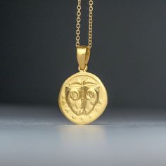 Solid gold ancient Greek coin necklace, inspired by the 5th century BC Delphi coin (Phokis). There is an image on both sides and can be worn either way. It pictures two rhyta (drinking vessels) in the form of ram's heads, above, two dolphins are swimming toward each other; ΔAΛΦ-I-KON in small letters below on the other side, the backside, it pictures a Quadripartite incuse square in the form of a coffered ceiling; each coffer decorated with a dolphin and laurel spray. This is a replica of an anc 14k Gold Amulet Coin Necklace Tarnish Resistant, Symbolic Yellow Gold Coin Pendant Necklace, Symbolic Yellow Gold Coin Necklace, 14k Gold Round Pendant Amulet Coin Necklace, Engraved 14k Gold Amulet Coin Necklace, Symbolic Yellow Gold Coin Medallion Necklace, Gold Symbolic Round Coin Necklace, Symbolic Yellow Gold Plated Coin Necklace, Symbolic Gold Plated Coin Necklace In Yellow Gold