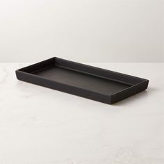 a black tray sitting on top of a white table