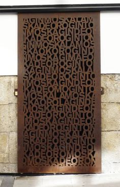 a metal door that has some type of words on it in the shape of letters