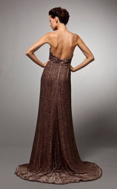 the back of a woman's dress, with her hands on her hips and one hand on her hip