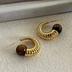 Material quality: metalTreatment process: electroplating Trendy Metal Earrings With Plating, Trendy Metal Plated Hoop Earrings, Brown Metal Hoop Jewelry, Geometric Hoop Earrings, Geometric Textures, Brown Stone, Stone Texture, Hook Earrings, Memorable Gifts