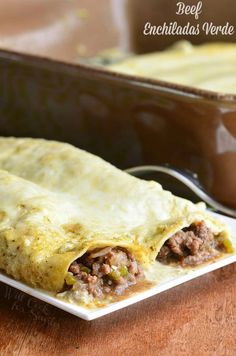 an enchiladas with meat and cheese on a plate