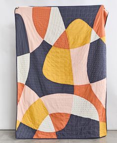 colorful patchwork quilt in navy blue, mustard yellow, orange, blush pink and natural white made with organic cotton & embroidered in India Graphic Quilt Patterns, Cute Quilt Patterns, Square Quilt Patterns, Minimalist Quilt, Modern Quilts Pink, Contemporary Patchwork, Orange Patchwork Quilt, Sunset Quilt, Cozy Quilt Designs