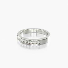 a white gold wedding band with channeled diamonds on the side, set in 18k white gold