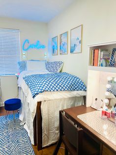 a bed room with a neatly made bed and desk