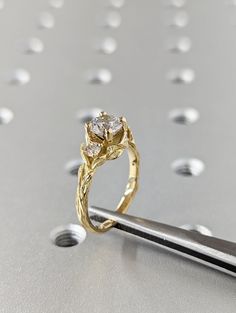 a gold ring sitting on top of a pair of scissors