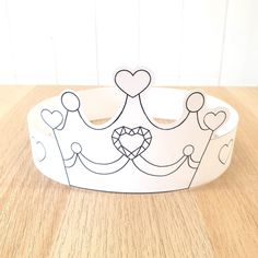 a paper crown sitting on top of a wooden table