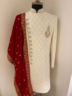 This sherwani comes with golden zardozi handwork. Colour options available. Customisation available. Includes- sherwani and bottom . Traditional Long Sleeve Kundan Kurta, Long Sleeve Kundan Traditional Wear For Wedding, Kundan Long Sleeve Traditional Wear For Wedding, Kundan Traditional Wear With Long Sleeves For Wedding, Long Sleeve Kundan Kurta For Eid, Festive Traditional Wear With Naqshi Drape, Red Bollywood Sherwani With Straight Kurta, Eid Sherwani With Dabka Work For Traditional Ceremonies, Festive Straight Kurta Sherwani With Naqshi