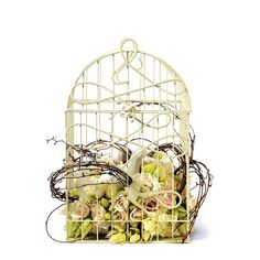 a white bird cage filled with lots of flowers