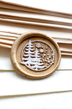 a wax stamp with a pine tree on it