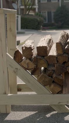 a pile of wood sitting on top of a wooden bench