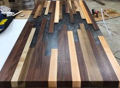 a table made out of wooden planks on top of a hard wood flooring