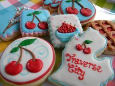 several decorated cookies with cherries on them