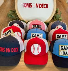 Step up to the plate in style with our Baseball Mom hats! Designed for the ultimate team supporter, these hats & visors offer both comfort and flair, featuring trendy designs and durable materials. Whether you're shading yourself from the sun during games or running errands around town, our baseball mom hats are the perfect accessory to show off your team pride. Choose from either the 'Merica, the Moms On Deck logo, Game Day in a chenille patch or a baseball in a chenille.  The hats can personalized with a chenille player's number.  The visors come with either the Moms on Deck logo or MOM in a baseball chenille patch.  Grab yours today and hit a style home run! Baseball Cap For Tailgating During Baseball Season, Curved Brim Hat With Letter Patch For Fans, Sports Fan Hat With Flat Bill For Baseball Season, Sports Fan Flat Bill Hats For Baseball Season, Curved Bill Hats With Letter Patch For Baseball Season, Game Day Baseball Season Trucker Hat With Curved Bill, Game Day Trucker Hat For Baseball Season, Game Day Trucker Hat With Curved Brim, Team-colored Snapback Baseball Cap For Game Day