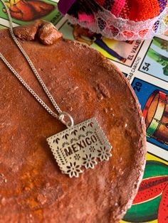 Beautiful necklace made of 925 silver by artisans from Guerrero, Mexico with a Papel Picado pendant, it is part of our Frida collection available only this month ✨This preorder may take 7 to 15 business days to ship, if you have any questions before ordering send us a message Measurements: 9.5" length / Papel Picado 1.5 cm CARE: -Do not apply perfume directly -Do not expose to cleaning chemicals -Store in jewelery box Artisan Sterling Silver Necklaces For Gifts, Artisan Sterling Silver Necklace Gift, Sterling Silver Stamped Necklaces, Stamped Sterling Silver Necklaces, Artisan Gift Necklaces, Traditional Silver Necklaces With Charms, Bohemian Sterling Silver Charm Necklaces For Gifts, Artisan Silver Necklace Stamped 925, Stamped Silver Sterling Necklace