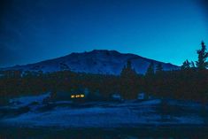 there is a mountain in the background at night