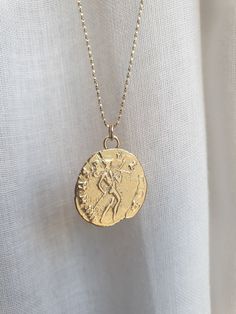 This 14k solid gold coin necklace was 100% handmade and has an antique Roman coin for a pendant. The necklace is available with 14k solid gold or 14k gold filled chain. The pendant is available in 9k or 14k solid gold. You can also buy the pendant only if you wish. Dimensions: The 14k gold necklace is available in multiple lengths. The antique coin pendent's diameter is 1.5 cm (0.6 inches) This ancient coin necklace is unique and beautiful and will serve you long and well. To see other necklaces Yellow Gold Coin Pendant Necklace In Sterling Silver, Yellow Gold Sterling Silver Coin Medallion Necklace, Antique Gold Sterling Silver Coin Necklace, Vintage Yellow Gold Coin Necklace, Tarnish Resistant, Antique Sterling Silver Gold Coin Necklace, Sterling Silver Gold Medallion Coin Necklace, Antique Coin Necklace Tarnish Resistant, Gold Plated Engraved Coin Medallion Necklace, Antique Coin-shaped Tarnish Resistant Necklace