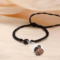 This is a mysterious bracelets, Personalized for the moment you love most on a projection bracelets! Engraved love never fades, and treasured memory will always be with you. Carry your Little cute photo hidden in the pendant, You can see the photo inside the pendant, or you can use it to illuminate the light and project your photo on the wall. The best dreamy gift for yourself and family, and friends. Customize Your Picture Projection Bracelets You can freely customize anything you like, including people, pets, scenery, and even symbol, and attach text as a souvenir. Please try to upload photos with high resolution, the higher the resolution, the more obvious the product effect. Meaningful Accessory & Memorial Gift This customized projection bracelets engraved with your favorite photo will Adjustable Black Promise Bracelet, Adjustable Black Bracelet For Promise, Black Adjustable Promise Bracelet, Couples' Black Promise Bracelets, Personalized Black Wristband For Gift, Personalized Black Wristband Gift, Couples' Black Braided Bracelets As Gift, Couples Black Braided Bracelet Gift, Adjustable Black Bracelets For Anniversary