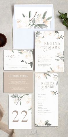 the wedding stationery is laid out on a table