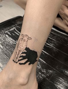 a person with a black and white tattoo on their foot