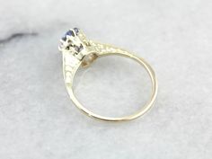 "This is a stunning early 1900's green gold engagement ring that has a rich luster! Utterly stunning, this vintage gold piece is lightly chased along the tall, polished shoulders. Green gold is created when gold is alloyed with sterling silver. The center stone of this incredible vintage setting is one of our loveliest sapphires! Blue as an October sky and filled with shine, this amazing stone is a perfect choice for this colorful setting! This ring would be amazing as an engagement ring, or sim Victorian 14k Gold Diamond Cut Rings, Vintage 14k Stamped Sapphire Ring For Formal Occasions, Art Deco 14k Stamped Promise Ring, Antique 14k Gold Round Diamond Ring, Antique 14k Gold Solitaire Jewelry, Victorian 14k Gold Cluster Ring For Anniversary, 14k Gold Engraved Ring With Rose Cut Diamonds, Heirloom Sapphire Ring In Yellow Gold, Antique Yellow Gold Engraved Ring