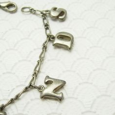 Vintage charm bracelet in silver tone with lobster clasp on a figaro chain bracelet. Slightly puffy two sided letter charms spell the word friends. A sweet vintage bracelet and mom would love from her daughter. Unsigned, in very good condition, 7 1/8 inch long. Find lots more vintage jewelry at Purple Daisy Jewelry! http://www.etsy.com/shop/purpledaisyjewelry Thanks a bunch for shopping for vintage jewelry at Purple Daisy Jewelry on Etsy! Vintage Personalized Dangle Jewelry, Personalized Vintage Dangle Jewelry, Silver Nickel-free Name Bracelet For Friendship, Vintage Adjustable Charm Bracelet For Everyday, Metal Charm Bracelet For Birthday And Mother's Day, Antique Silver Nickel-free Charm Bracelet For Gift, Metal Charm Bracelets For Birthday, Antique Silver Charm Bracelet As Gift, Antique Silver Metal Charm Bracelet Gift