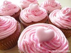 cupcakes with pink frosting and hearts on them