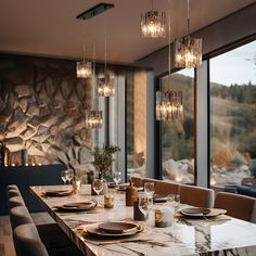 a dining room table with plates and place settings in front of a large window overlooking the mountains