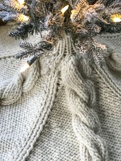 a knitted christmas tree skirt with lights on it