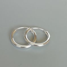 16 mm sterling silver ear hoops. Dimensions: 2 x 16 mm Price listed is for a PAIR of hoops. These earrings are made of 925 hypoallergenic sterling silver Can be packaged in a gift box. I can include a personal message from you if needed You are welcome to contact me at... bhavnakwintra1956@gmail.com For more beautiful pieces from my shop, please browse 👇 TOE RINGS: https://www.etsy.com/your/shops/TheSilverGame/tools/listings/section:27020628,view:table EAR HOOPS: https://www.etsy.com/your/shops Wanderlust Jewelry, Handmade Clay Jewelry, Girl Jewelry