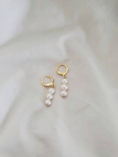 These freshwater pearl huggies are the perfect touch of elegance for any occasion. Both standard and clip on huggie hoops are available, all hypoallergenic and nickel free. Standard gold hoops are hypoallergenic and nickel free (18 karat gold plated). Standard silver hoops are hypoallergenic and nickel free (platinum plated). Clip on gold hoops are hypoallergenic and nickel free (18 karat gold plated). Clip on silver hoops are hypoallergenic and nickel free (platinum plated). Please feel free to Everyday Pearl Drop Dangle Huggie Earrings, Hypoallergenic Pearl Huggie Hoop Earrings, White Hypoallergenic Dangle Cartilage Earrings, Minimalist Pearl Dangle Huggie Earrings, White Pearl Huggie Earrings With Pearl Charm, Pearl White Dangle Hoop Earrings With Pearl Charm, Pearl White Dangle Earrings For Everyday, Minimalist Pearl Huggie Earrings As A Gift, Hypoallergenic Pearl Huggie Earrings